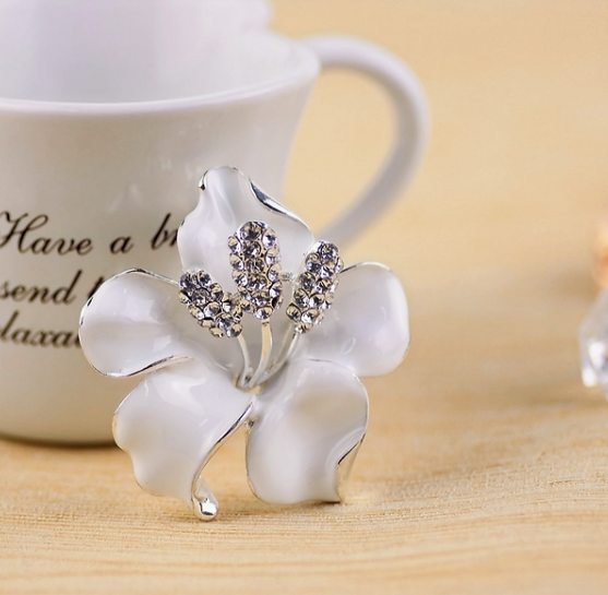 Elegant Silver-Tone White Enamel Floral Brooch with Crystal Accents