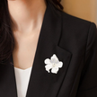 Elegant Silver-Tone White Enamel Floral Brooch with Crystal Accents