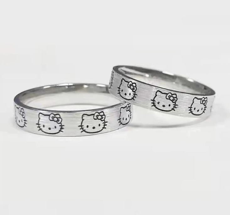 Two silver rings with Hello Kitty face and bow design on a white background