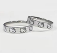 Two silver rings with Hello Kitty face and bow design on a white background