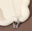 Silver necklace with a decorative pendant on a beige stone background