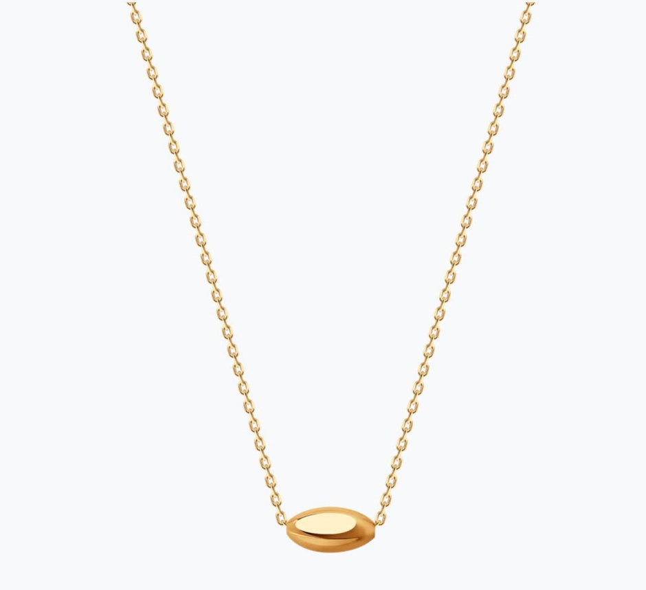 Gold necklace with a small pendant on a white background