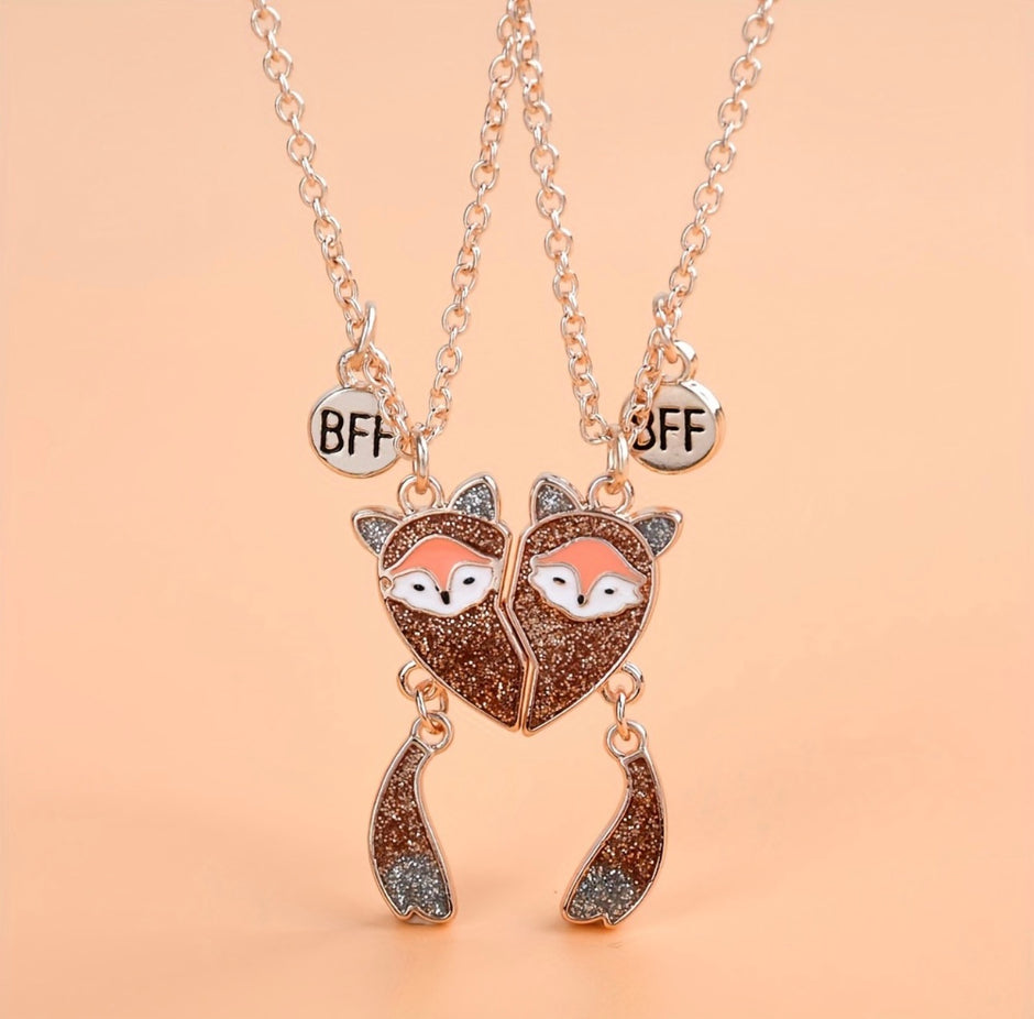 Two fox-shaped necklaces with 'BFF' charms on a beige background
