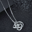 Silver necklace with a heart-shaped pendant on a dark background