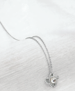 Silver necklace with a pendant on a white background
