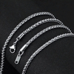 Silver chain necklace with clasp on a black background